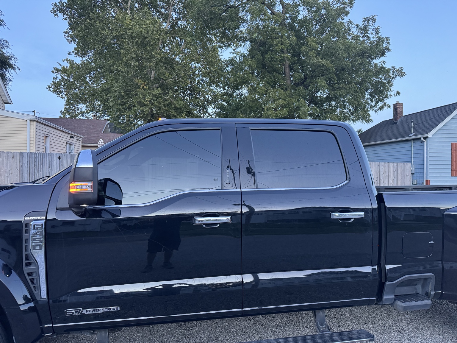 Driver-side view of 2023 Ford F-450 Platinum with ceramic tint on its two front windows