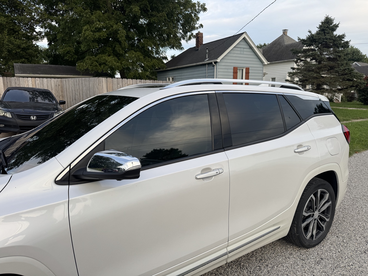 Side view of white 2021 GMC Terrain showing tinted front windows