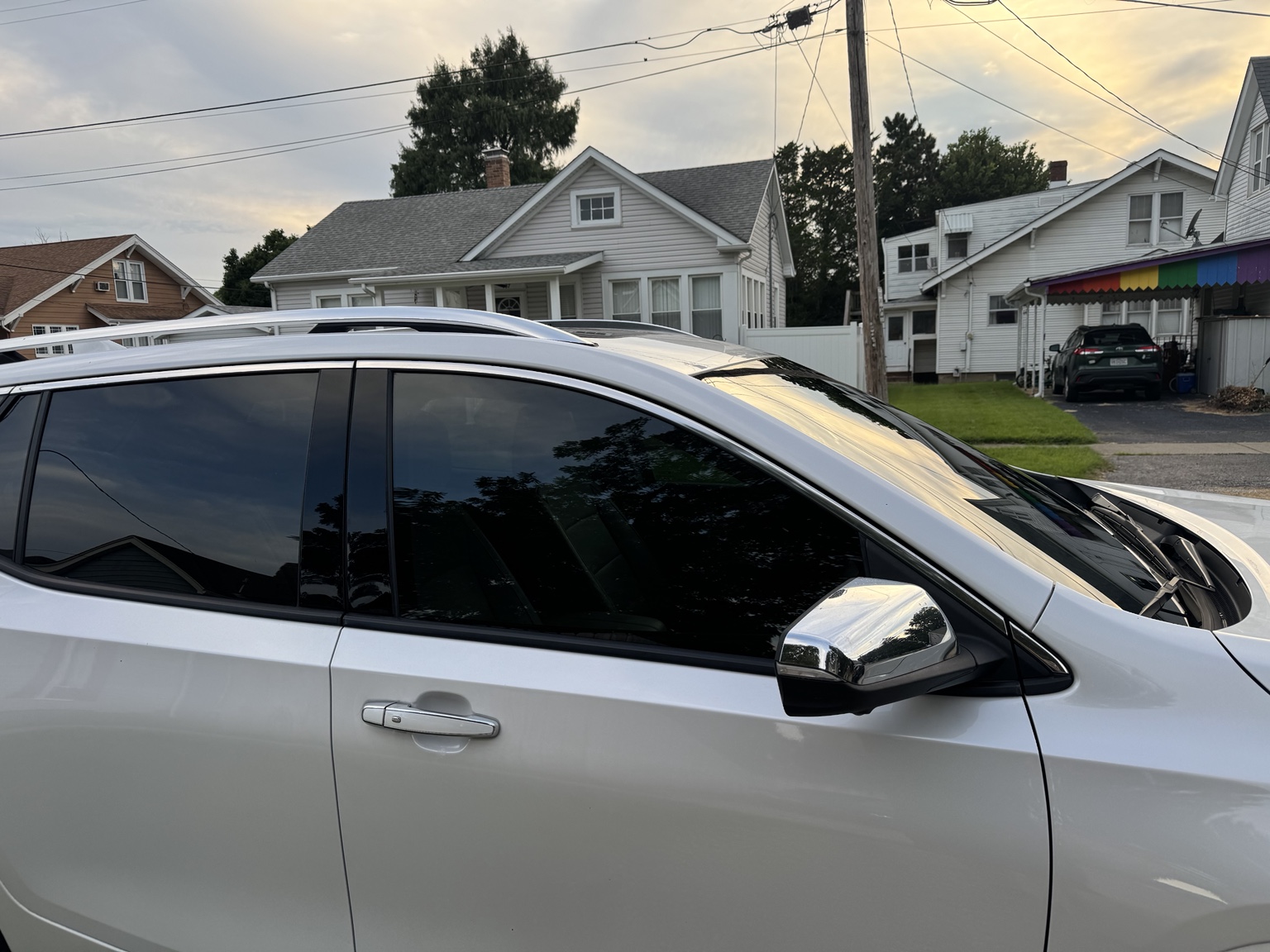 Opposite side view of white 2021 GMC Terrain showing tinted front window