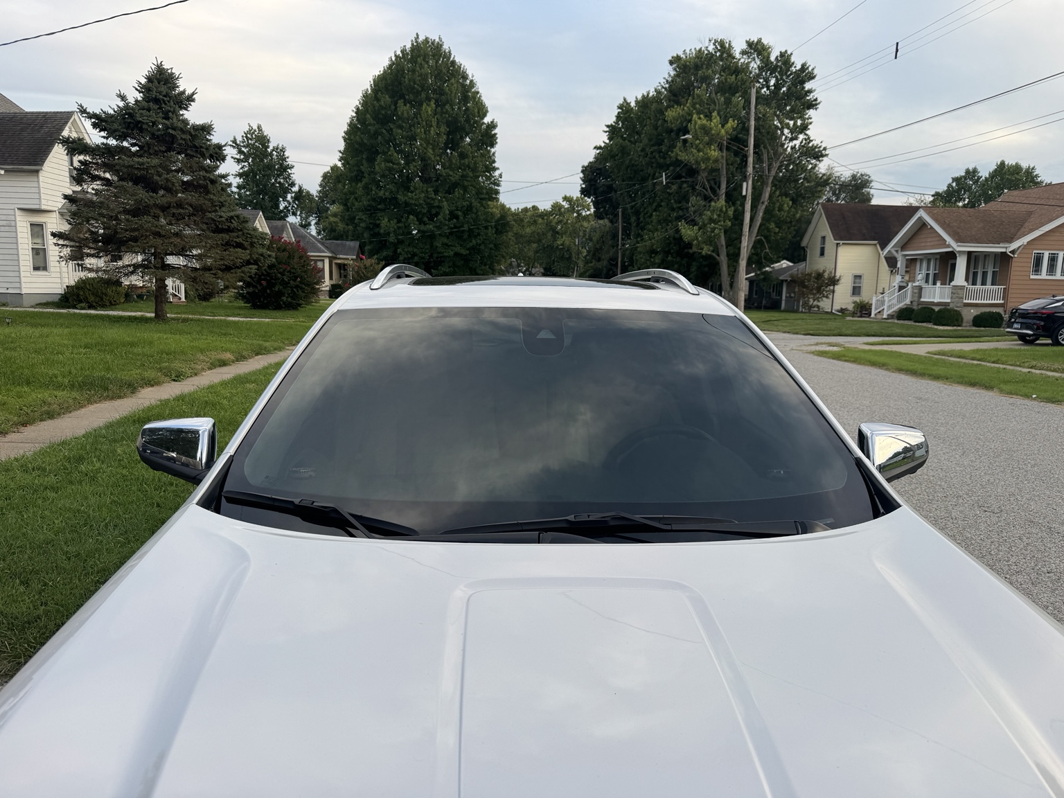 Front view of white 2021 GMC Terrain showing tinted full windshield
